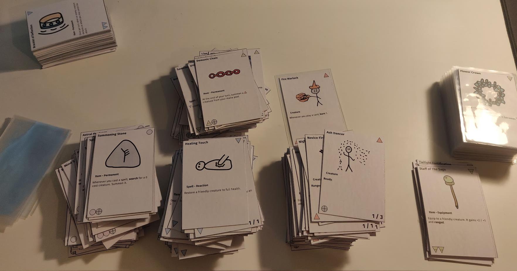Piles of Hexal cards on a white desk.